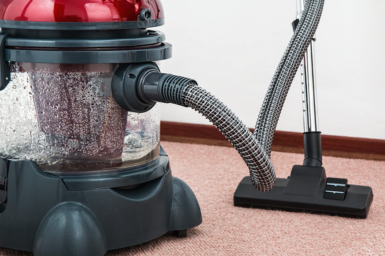 our-story Close-up of a modern vacuum cleaner with water filtration on carpet floor indoors.